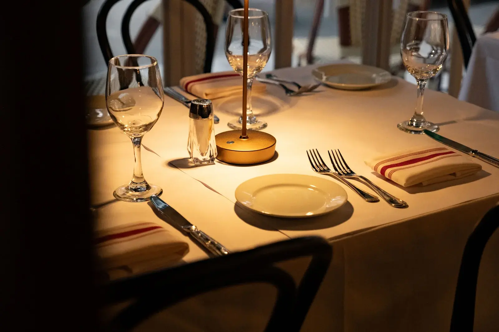A warmly lit table set for guests at Sutton Place